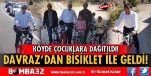 BİSİKLET İLE YOLDAN GEÇTİ, ÇOCUKLARA HEDİYE ETTİ