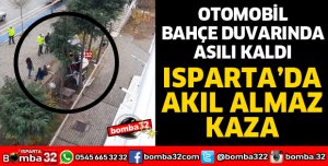 OTOMOBİL BAHÇE DUVARINDA ASILI KALDI