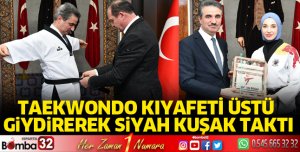 Taekwondo kıyafeti üstü giydirerek siyah kuşak taktı